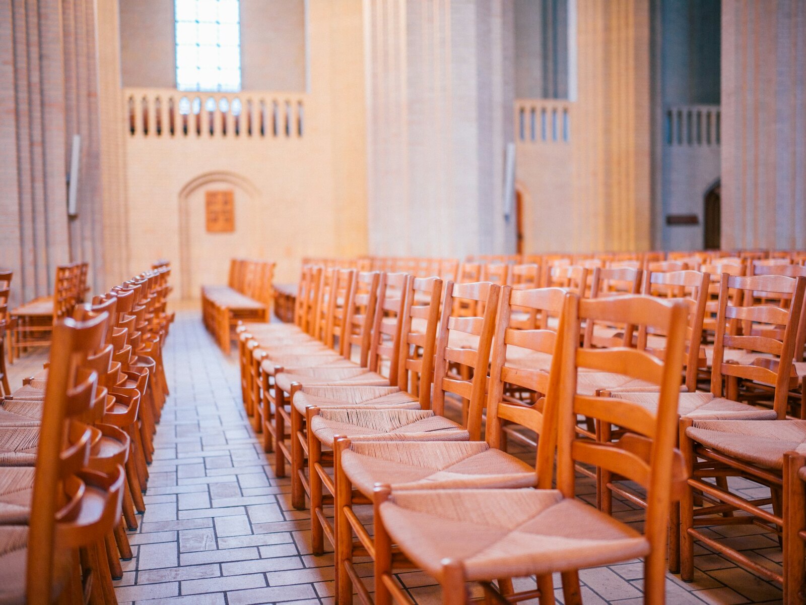 The inside of St Martins, with rows of wooden chairs and soft daylight